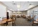 Meeting room featuring tables, chairs, neutral walls, and light carpet flooring with ample seating for gatherings and discussions at 1046 Almondwood Dr, Trinity, FL 34655