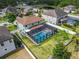 Aerial view of a pool and backyard, surrounded by a screen enclosure and white fence for added privacy at 11804 Harpswell Dr, Riverview, FL 33579