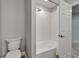 Clean bathroom with a shower-tub combo and a toilet, offering a functional space in the home at 11804 Harpswell Dr, Riverview, FL 33579