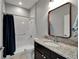 Bathroom features a granite vanity, enclosed shower, and modern lighting and accessories at 11804 Harpswell Dr, Riverview, FL 33579