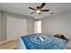 Cozy bedroom featuring a ceiling fan, closet, and a comfortable bed with a blue Tampa Bay Lightning themed comforter at 11804 Harpswell Dr, Riverview, FL 33579