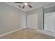 Bedroom with neutral carpeting features double closet, ceiling fan, and neutral color palette at 11804 Harpswell Dr, Riverview, FL 33579