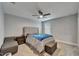 Bedroom featuring neutral tones, ceiling fan and natural light; carpeted floor and storage bench at 11804 Harpswell Dr, Riverview, FL 33579