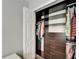 Walk-in closet providing plenty of space for storage and organization with custom shelving and rods at 11804 Harpswell Dr, Riverview, FL 33579