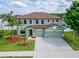 Spacious home with a three-car garage, a well-manicured lawn and beautiful landscaping at 11804 Harpswell Dr, Riverview, FL 33579