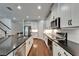 Bright kitchen with stainless appliances, a tile backsplash, and modern black hardware at 11804 Harpswell Dr, Riverview, FL 33579