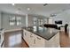 Open-concept kitchen island with seating overlooks the living area for easy interaction at 11804 Harpswell Dr, Riverview, FL 33579