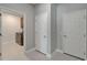 Hallway provides access to mud room/laundry room with storage, utility sink, and laundry machines at 11804 Harpswell Dr, Riverview, FL 33579