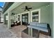 Inviting covered patio with ceiling fans and comfortable seating, perfect for outdoor relaxation and entertaining at 11804 Harpswell Dr, Riverview, FL 33579