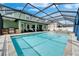Refreshing pool area, a delightful extension of the home, with an adjacent outdoor kitchen and relaxing patio at 11804 Harpswell Dr, Riverview, FL 33579