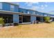 Spacious backyard of townhouse with a screened lanai, and an air conditioning unit at 12805 Kings Crossing Dr, Gibsonton, FL 33534