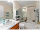 Clean and simple bathroom with shower/tub combination and a large mirror at 12805 Kings Crossing Dr, Gibsonton, FL 33534