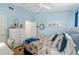Brightly painted bedroom with blue accents, a ceiling fan, and stylish coastal decor at 12805 Kings Crossing Dr, Gibsonton, FL 33534
