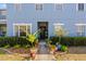 Charming entryway with a variety of potted plants and a decorative wreath on the door at 12805 Kings Crossing Dr, Gibsonton, FL 33534