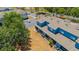 An aerial view shows a blue two-story home with lush landscaping and a nearby parking area at 12805 Kings Crossing Dr, Gibsonton, FL 33534