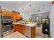 Well-equipped kitchen with stainless steel appliances and a breakfast bar with a sink at 12805 Kings Crossing Dr, Gibsonton, FL 33534