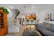 Comfortable living room with stairs, an open kitchen, and stylish modern decor at 12805 Kings Crossing Dr, Gibsonton, FL 33534