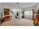 Bright living room with a comfortable seating area, front door, and natural lighting at 12805 Kings Crossing Dr, Gibsonton, FL 33534