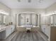 Bright bathroom featuring a tub, double sinks, tile floor, and lots of windows at 12902 Grand Traverse Dr, Dade City, FL 33525