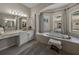 Elegant bathroom with a large soaking tub, double sinks, and plenty of natural light at 12902 Grand Traverse Dr, Dade City, FL 33525