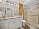 Bathroom features a glass-enclosed shower, a vanity with great lighting, and a decorative woven shade at 12902 Grand Traverse Dr, Dade City, FL 33525
