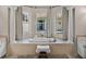 Bright bathroom features large soaking tub surrounded by windows and columns, offering a spa-like experience at 12902 Grand Traverse Dr, Dade City, FL 33525