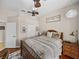 Bedroom with ceiling fans, wood floors, closet and sign on wall at 12902 Grand Traverse Dr, Dade City, FL 33525