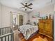 Bedroom with sliding glass doors leading to lanai; features wood floors and decorative furnishings at 12902 Grand Traverse Dr, Dade City, FL 33525