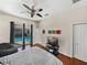 Bedroom with ceiling fan and door to the pool at 12902 Grand Traverse Dr, Dade City, FL 33525