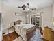 Cozy bedroom with wood floors, ceiling fans, and sliding glass door to the screened-in patio at 12902 Grand Traverse Dr, Dade City, FL 33525