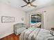 Light bedroom with wood floors and crib features sliding glass doors to the screened-in patio at 12902 Grand Traverse Dr, Dade City, FL 33525