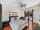 Bedroom with wood floors leads to the screened pool area at 12902 Grand Traverse Dr, Dade City, FL 33525