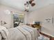 Bright bedroom with sliding glass door to the screened-in patio and wood floors at 12902 Grand Traverse Dr, Dade City, FL 33525