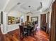 Formal dining room featuring elegant chandelier, detailed ceiling, and beautiful wood flooring, perfect for gatherings at 12902 Grand Traverse Dr, Dade City, FL 33525