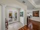Inviting foyer with marble floors, leading to a view of the dining and kitchen areas through glass doors at 12902 Grand Traverse Dr, Dade City, FL 33525