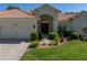 Beautiful home with a manicured lawn, complemented by lush landscaping and an elegant entrance at 12902 Grand Traverse Dr, Dade City, FL 33525
