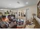 Spacious living room with hardwood floors, sliding glass doors, stylish furniture and connecting rooms at 12902 Grand Traverse Dr, Dade City, FL 33525