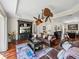 Bright living room with stylish furnishings, hardwood floors, and a unique chandelier ceiling fan at 12902 Grand Traverse Dr, Dade City, FL 33525