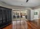 Bright living room with hardwood floors and sliding glass doors to the pool area at 12902 Grand Traverse Dr, Dade City, FL 33525
