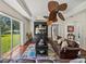 Comfortable living room featuring hardwood floors, sliding glass doors to yard, and a modern ceiling fan at 12902 Grand Traverse Dr, Dade City, FL 33525