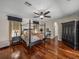 Spacious main bedroom boasts hardwood floors, ceiling fan, and lots of space, creating a cozy, stylish retreat at 12902 Grand Traverse Dr, Dade City, FL 33525