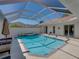 Enjoy outdoor living with this screened in pool with hot tub at 12902 Grand Traverse Dr, Dade City, FL 33525