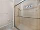 Shower with glass doors at 12902 Grand Traverse Dr, Dade City, FL 33525