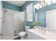 Well-lit bathroom with a glass-enclosed shower, vanity, and toilet at 12925 Tar Flower Dr, Tampa, FL 33626