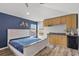 Bedroom with wood-look floors, kitchenette, and large windows for natural light at 12925 Tar Flower Dr, Tampa, FL 33626