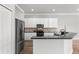 Bright kitchen features white cabinets, stainless steel appliances, and black countertops at 12925 Tar Flower Dr, Tampa, FL 33626