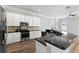 Open kitchen boasts white cabinetry, stainless steel appliances, and granite countertops at 12925 Tar Flower Dr, Tampa, FL 33626