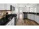 Modern kitchen featuring stainless steel appliances, granite countertops, and white cabinetry at 12925 Tar Flower Dr, Tampa, FL 33626