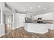 Open kitchen with stainless appliances, granite countertops, bar seating, and hardwood floors at 12925 Tar Flower Dr, Tampa, FL 33626