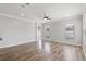 Bright, open living room featuring wood-look floors, neutral walls, and ample natural light at 12925 Tar Flower Dr, Tampa, FL 33626